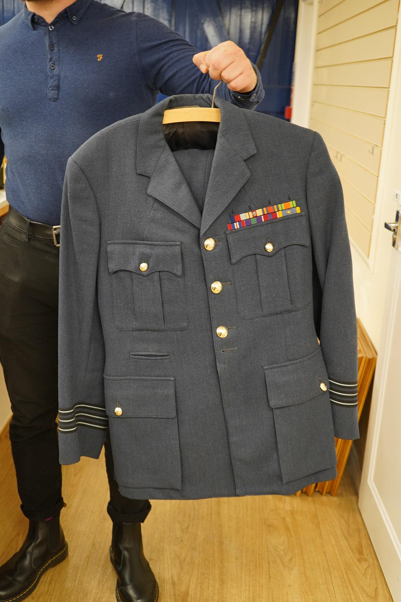 Two post-WWII RAF uniforms, one with applied medal ribbons, an RAF cap, and related buttons, together with a bowler hat and two Arab daggers. Condition - good